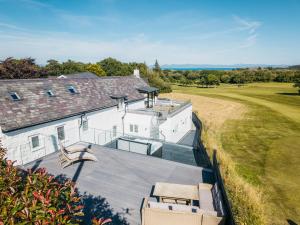 an aerial view of a house with a large roof at Stunning Abersoch Cottage by golf course & beach in Abersoch