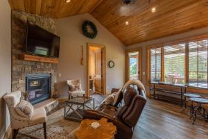 a living room with a fireplace and a tv at Valley View in Banner Elk