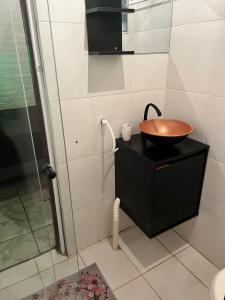 a bathroom with a sink and a shower at Chácara Pedacinho do Céu in Extrema