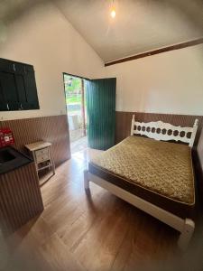 a bedroom with a large bed in a room at Chácara Pedacinho do Céu in Extrema