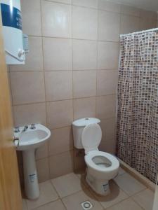 a bathroom with a toilet and a sink at El Palacio in La Punta
