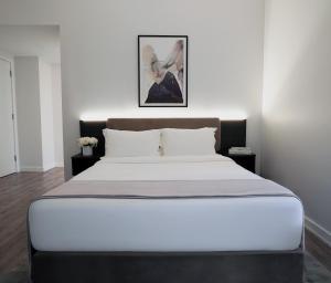 a bedroom with a large bed with white sheets at One Dutch Hotel in New York