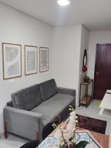 a living room with a couch and a table at Apartamento 520C in Maringá +1 photo