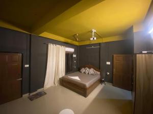 a small bedroom with a bed and a window at Haven Stay in Dibrugarh