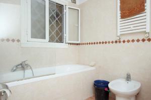 a bathroom with a tub and a toilet and a sink at Comfy in the Heart of Roman nightlife in Rome +15 photos