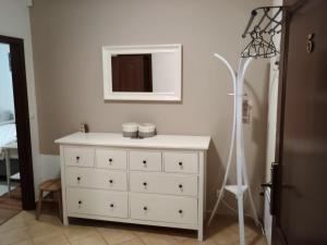 a white dresser in a room with a mirror at Apartmán Viktória 5 in Ružomberok +33 photos
