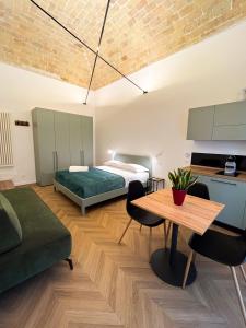 a bedroom with a bed and a table in a room at Residenza Veneto 80 in Vasto