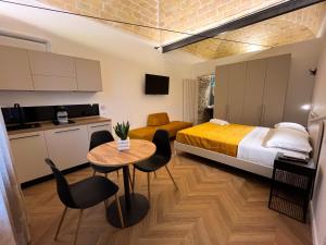 a bedroom with a bed and a table and chairs at Residenza Veneto 80 in Vasto
