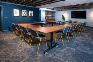 a conference room with a long table and chairs at Holiday Inn Derby Riverlights by IHG in Derby