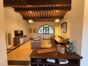 a living room with a table and a couch at Antico Granaio di LEO Via Antonia 60 in Ponte Pattoli