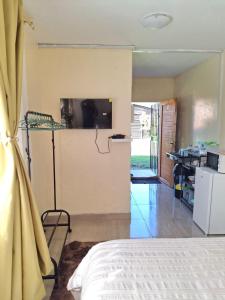 a bedroom with a bed and a television in a room at Cosy Beds Web in eMalahleni