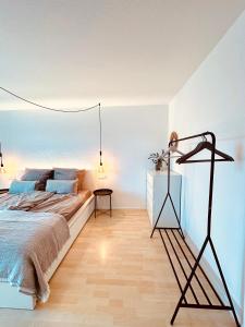 a bedroom with a large bed and a lamp at Apartment am Baumoval in Böblingen