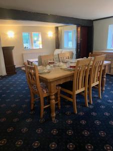 a dining room with a wooden table and chairs at The Lord Nelson Inn in Marshfield +8 photos