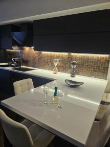 a kitchen with a white table with wine glasses on it at Blu Petrolio Stay-Karabas Apartments in Vicenza
