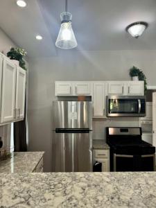 a kitchen with a stainless steel refrigerator and a microwave at Highland Apartment in Columbus