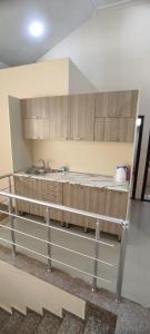 a kitchen with wooden cabinets and a sink at İzmir can hotel in Baku