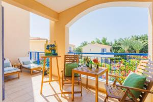a patio with chairs and tables and a balcony at Mediterranean Dream by the Sea in Paphos City