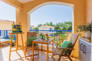 a balcony with a table and chairs on a balcony at Mediterranean Dream by the Sea in Paphos City