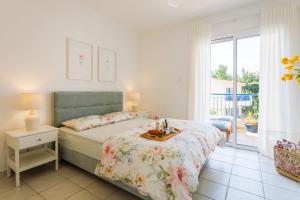 a bedroom with a bed with a table on it at Mediterranean Dream by the Sea in Paphos City +37 photos