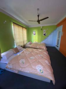 a bedroom with a large bed with a pink comforter at Homemade guest house and netflix in Bhaktapur