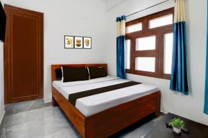 Ένα ή περισσότερα κρεβάτια σε δωμάτιο στο Hotel O Welcome Guest House