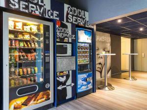 a vending machine in a store with food and drinks at ibis budget Caen Hérouville in Hérouville-Saint-Clair
