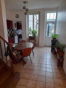 a kitchen and dining room with a table and chairs at chambre dans maison au mans in La Celle-sous-Gouzon
