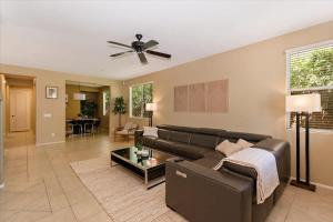 a living room with a couch and a ceiling fan at Walk to the Festivals - Private Pool & Spa in Indio +54 photos