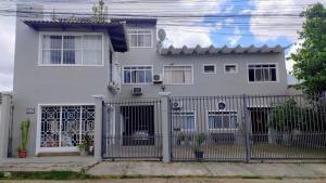 a white house with a fence in front of it at Casa e Ateliê de pintura Neiva Mario in São Gabriel +8 photos