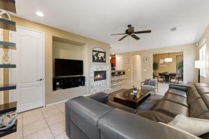 a living room with a couch and a fireplace at Walk to the Festivals - Private Pool & Spa in Indio