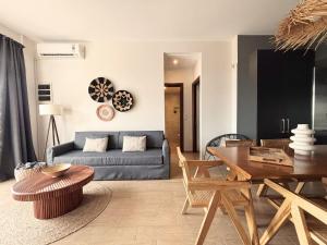 a living room with a couch and a table at Superior 3-Bedroom Villa Cassiope with Private Pool and Breathtaking Sea Views in Megali Ammos