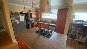 a kitchen with a counter top and a refrigerator at The Shire in Oakland