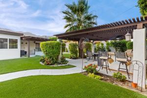 a backyard with a gazebo and green lawn at Desert Paradise Retreat - Pool Hot Tub & Fire Pit in La Quinta
