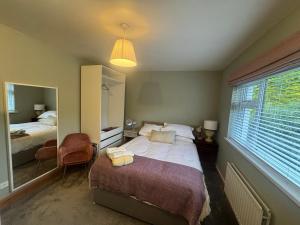 a bedroom with a bed and a large window at Holywood Hideaway 2 bedroom retreat in Cultra