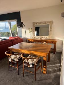 a living room with a wooden table and a mirror at Holywood Hideaway 2 bedroom retreat in Cultra