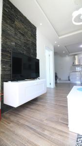 a living room with a flat screen tv on a wall at Villa Omoris 3 bedrooms Trou aux Biches, Sea Access in Trou aux Biches