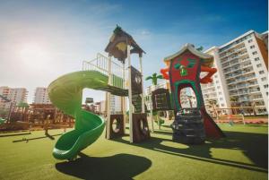 a playground with a slide in a park at THE PALMiA I iskele I Trikomo in Aglantzia