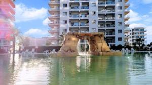 a fountain in the water in front of a building at THE PALMiA I iskele I Trikomo in Aglantzia