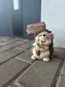 ルドビコビツェ・クウォツキエにあるNest Hausの頭に歓迎のサインをつけたおもちゃの犬