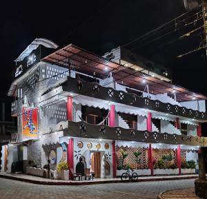 a building with lights on it at night at Royal Galápagos Inn in Puerto Baquerizo Moreno