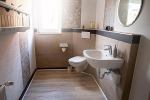 a small bathroom with a sink and a toilet at Ferienhaus Lotte in Vöhl +24 photos