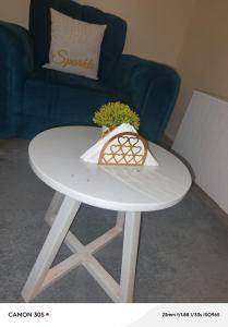 a white table with a vase on top of it at Kitengela Homes in Kitengela 