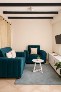 a living room with a blue couch and a table at Kitengela Homes in Kitengela 