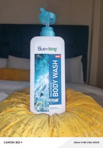 a bottle of blue flinging detergent sitting on a bed at Kitengela Homes in Kitengela 