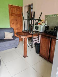a living room with a couch and a table at Black Widow in Horquetas