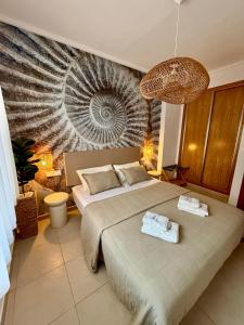 a bedroom with a bed with two towels on it at Alicante Hills Apartment Blue in Alicante