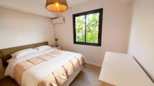 a bedroom with a bed and a window at VILLA MAGIC - Ocean Views with Pool, Starlink WiFi, Cistern & Generator in Oyster Pond