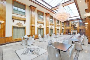 a large room with tables and chairs and a chandelier at Woodbine Hotel & Suites in Toronto