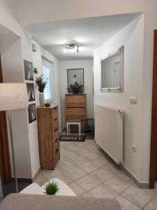 a living room with a mirror and a dresser at Apartma Ariana in Loče pri Poljčanah +3 photos