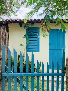 a blue fence in front of a house with a blue door at Casa Indigo Blue Jeri in Jericoacoara
